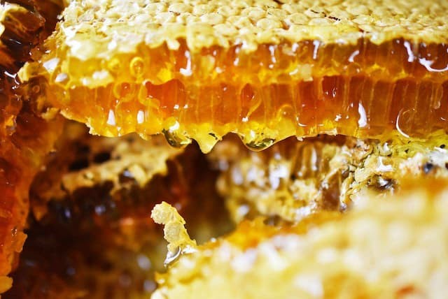 How is honey produced